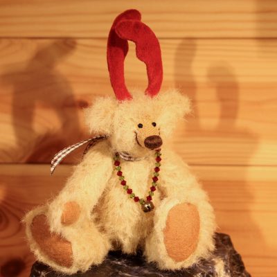 Miniatur Teddy als Rentier aus beigem Alpaka mit rotem Geweih und einer Kette samt Miniglocke